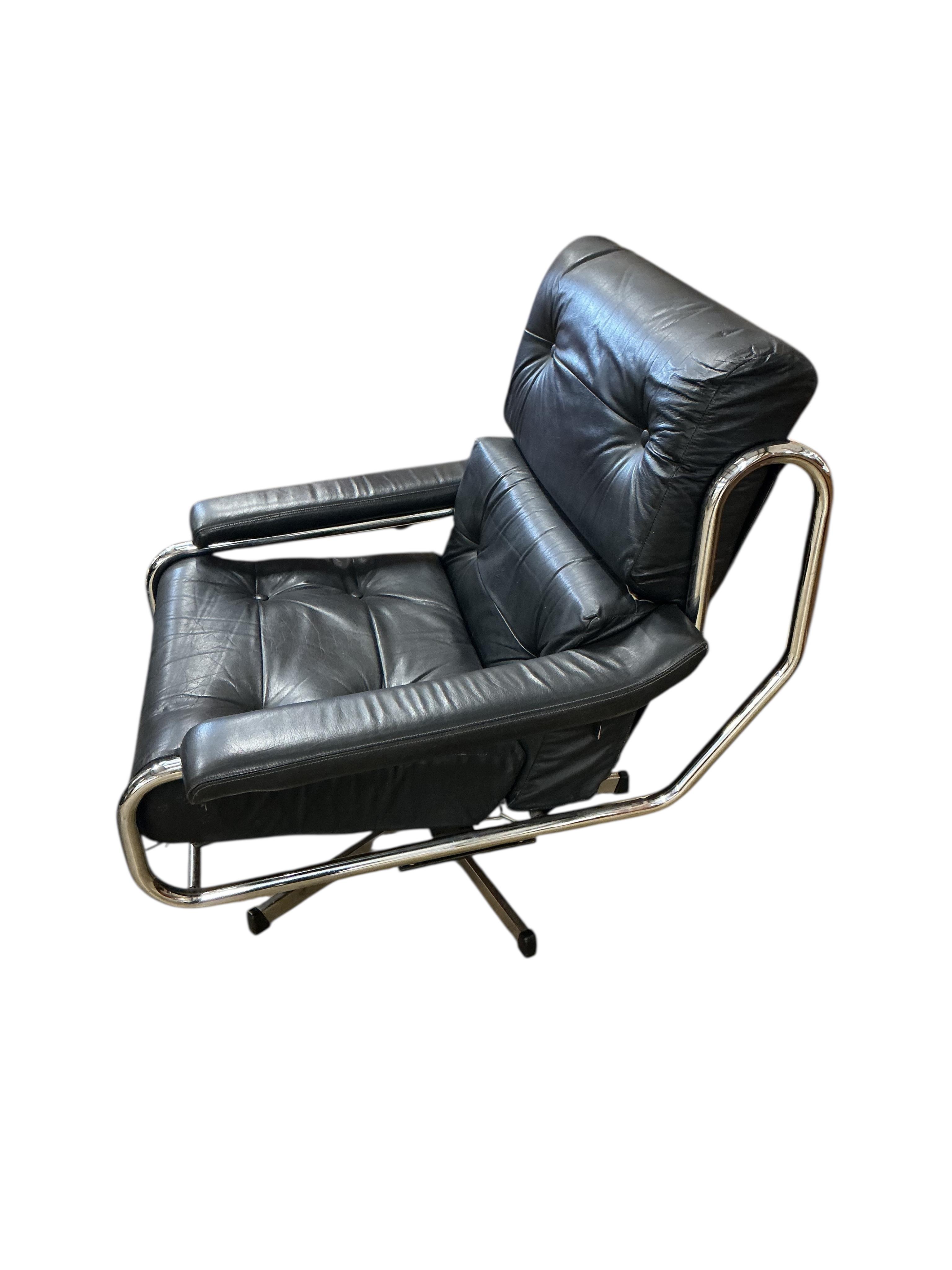 A near pair of mid century Pieff black and green leather swivel lounge chairs on chrome five prong bases, width 86cm, depth 94cm, height 91cm, one with a footstool